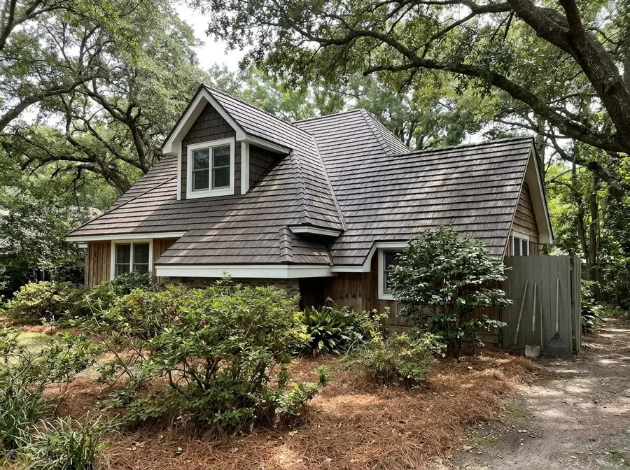 Steel shingle roof pressed in a wood-shake pattern on a cottage-style house